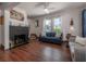 Inviting living room with a brick fireplace and hardwood floors at 3116 W Wallcraft, Tampa, FL 33611