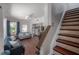 Comfortable living room featuring wood floors, a ceiling fan, and a staircase with mosaic tiles at 3116 W Wallcraft, Tampa, FL 33611