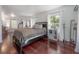 A spacious main bedroom featuring an area rug, an ensuite bathroom, and natural light at 3116 W Wallcraft, Tampa, FL 33611