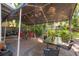 Large covered patio with dining and seating areas surrounded by lush greenery at 3116 W Wallcraft, Tampa, FL 33611