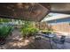 Covered patio has string lights, table and chairs, and beautiful landscaping at 3116 W Wallcraft, Tampa, FL 33611