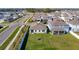 An aerial view of the house with a green lawn and neighborhood surroundings at 35524 Quartz Lake Dr, Zephyrhills, FL 33541