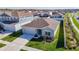 Aerial view showcasing the home's facade, landscaping, and surrounding neighborhood at 35524 Quartz Lake Dr, Zephyrhills, FL 33541