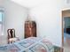 Bright bedroom featuring a window, a quaint quilt, and a classic wooden dresser, creating a cozy and inviting space at 35524 Quartz Lake Dr, Zephyrhills, FL 33541