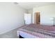 Simple bedroom with a view into the bathroom at 35524 Quartz Lake Dr, Zephyrhills, FL 33541