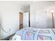 Bright bedroom featuring a quaint quilt, and a view into the hallway, creating a cozy and inviting space at 35524 Quartz Lake Dr, Zephyrhills, FL 33541
