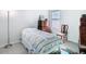 Bright bedroom featuring a window, a quaint quilt, and a classic wooden dresser, creating a cozy and inviting space at 35524 Quartz Lake Dr, Zephyrhills, FL 33541