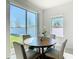 Dining area with large windows providing natural light, complemented by a wooden table and comfortable seating at 35524 Quartz Lake Dr, Zephyrhills, FL 33541