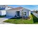 Charming single-story home with a well-kept lawn and attached two-car garage at 35524 Quartz Lake Dr, Zephyrhills, FL 33541