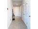 Inviting hallway with neutral paint and tile floor at 35524 Quartz Lake Dr, Zephyrhills, FL 33541