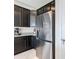 Stainless steel refrigerator paired with dark cabinetry and granite countertops at 35524 Quartz Lake Dr, Zephyrhills, FL 33541