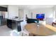 Open-concept kitchen flows into the living and dining areas, showcasing the island and appliances at 35524 Quartz Lake Dr, Zephyrhills, FL 33541