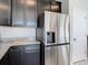 A stainless steel refrigerator complements the dark cabinets and granite countertops at 35524 Quartz Lake Dr, Zephyrhills, FL 33541
