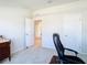 Office space featuring neutral walls, plush carpeting, and a doorway, suited for a productive and comfortable workspace at 35524 Quartz Lake Dr, Zephyrhills, FL 33541