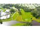 Overhead view of a golf course community with water features and surrounding residential area at 37042 Lois Ave, Zephyrhills, FL 33542
