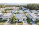 Aerial view of a vibrant community with well-maintained homes, manicured lawns, and charming carports at 37042 Lois Ave, Zephyrhills, FL 33542