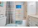 Clean, well-maintained bathroom featuring a shower-tub combo and vanity with storage at 37042 Lois Ave, Zephyrhills, FL 33542