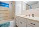 Clean bathroom featuring a shower-tub combo, vanity with storage, and neutral tile at 37042 Lois Ave, Zephyrhills, FL 33542