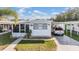Charming single-story home with a well-maintained lawn and covered parking at 37042 Lois Ave, Zephyrhills, FL 33542