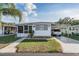 Charming single-story home with a well-maintained lawn and covered parking at 37042 Lois Ave, Zephyrhills, FL 33542
