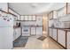 Functional kitchen featuring white cabinets and essential appliances at 37042 Lois Ave, Zephyrhills, FL 33542