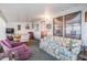 Bright living room with floral sofa, ample light, and casual dining area at 37042 Lois Ave, Zephyrhills, FL 33542