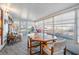 Light-filled sunroom with large windows, dining table, and comfortable seating at 37042 Lois Ave, Zephyrhills, FL 33542