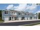 Row of two-story townhomes featuring blue paint, light-colored doors, and a garage at 4113 Goldheart Blvd, Bradenton, FL 34208