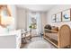Serene Bedroom features a wooden crib, rocking chair, soft rug, and bright window at 4117 Goldheart Blvd, Bradenton, FL 34208