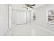 Bright bedroom features a ceiling fan, closet, and white marble floors at 4208 E Sandalwood S Cir, Tampa, FL 33617