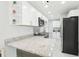 Modern kitchen boasts granite countertops, stainless steel appliances, and ample storage at 4208 E Sandalwood S Cir, Tampa, FL 33617