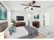 Spacious main bedroom featuring a ceiling fan, modern decor, and ensuite access at 4208 E Sandalwood S Cir, Tampa, FL 33617