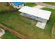 Aerial view of the backyard with a lush lawn and a detached patio at 506 Clearfield Rd, Brandon, FL 33511