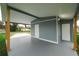 Covered carport featuring durable flooring and two convenient storage spaces with doors at 506 Clearfield Rd, Brandon, FL 33511