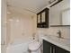 Cozy bathroom featuring a tub, toilet, and vanity with a mirror and storage at 5820 N Church Ave # 430, Tampa, FL 33614