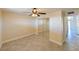 Sunny bedroom includes tile flooring, a fan, mirrored closet, and neutral walls at 5820 N Church Ave # 430, Tampa, FL 33614