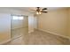 Comfortable bedroom with mirrored closet doors, tile floors, fan, and natural light at 5820 N Church Ave # 430, Tampa, FL 33614