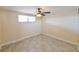 Bright bedroom features neutral walls, tile flooring, a fan, and a sunny window at 5820 N Church Ave # 430, Tampa, FL 33614