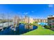 Beautiful community view overlooking a pond with mature trees and a swimming pool at 5820 N Church Ave # 430, Tampa, FL 33614