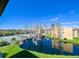 Relaxing community view showcasing the tennis court, pond, and residential buildings at 5820 N Church Ave # 430, Tampa, FL 33614