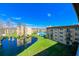 Scenic view of the community featuring lush landscaping, a lake, and a sparkling pool at 5820 N Church Ave # 430, Tampa, FL 33614