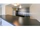 This kitchen includes stainless steel appliances, sleek cabinets, and a breakfast bar area at 5820 N Church Ave # 430, Tampa, FL 33614