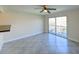 Bright living room features tile flooring, fan, and sliding glass doors to the balcony at 5820 N Church Ave # 430, Tampa, FL 33614