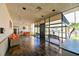 Well lit community lobby features tile floors, ample seating, and glass wall overlooking outside sitting area at 5820 N Church Ave # 430, Tampa, FL 33614