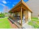 Exterior shot of community pool house with ceiling fan and chairs; blue sky and grass at 5820 N Church Ave # 430, Tampa, FL 33614
