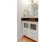 Elegant powder room with decorative mirror, gold fixtures, vanity and dark countertop at 6290 Bahia Del Mar Cir # 5, St Petersburg, FL 33715