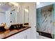 Bathroom features granite counters, gold fixtures, glass enclosed shower with white marble-patterned tile at 6290 Bahia Del Mar Cir # 5, St Petersburg, FL 33715