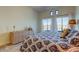 Bright bedroom features blue patterned bedding, water view, and matching wicker dresser at 6290 Bahia Del Mar Cir # 5, St Petersburg, FL 33715