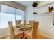 Cozy dining area with glass table and four rattan chairs, complemented by natural light at 6290 Bahia Del Mar Cir # 5, St Petersburg, FL 33715