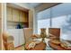 Bright dining area featuring a glass table, rattan chairs, and convenient laundry access at 6290 Bahia Del Mar Cir # 5, St Petersburg, FL 33715